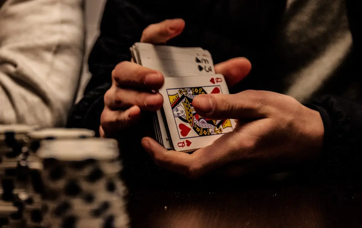 Dealer holding playing cards